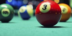 A Vintage style photo from a billiard balls in a pool table. Noise added for a film effect- Clearwater Pools